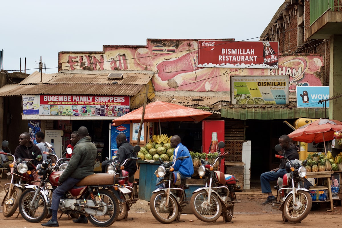 A row of shops and boda bodas on a street in Uganda